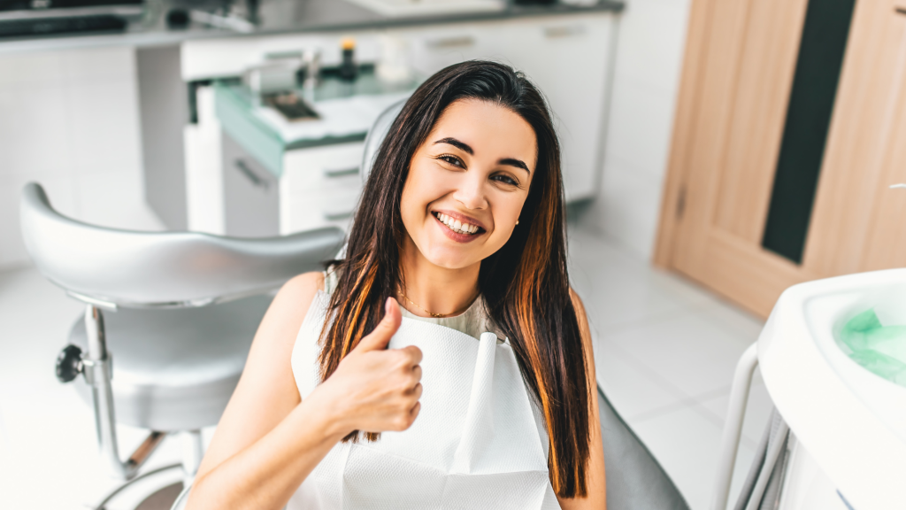 Image of woman giving thumbs up after root canal procedure